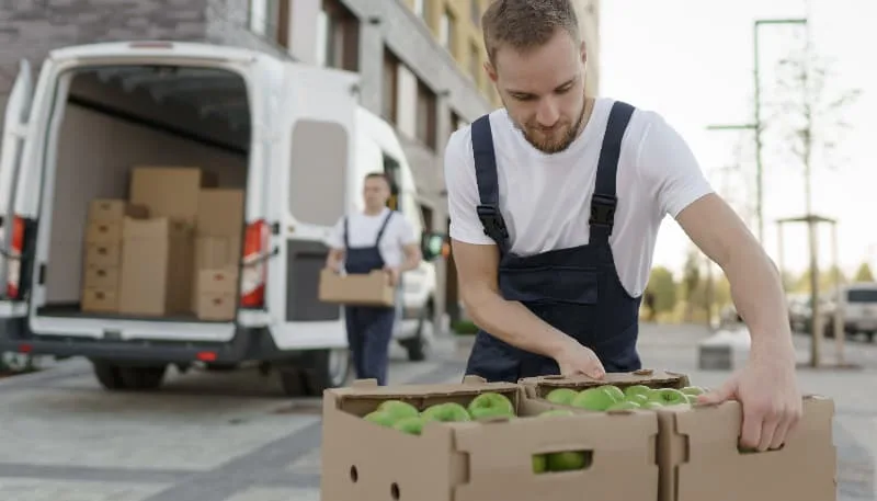 man loading fruit into van